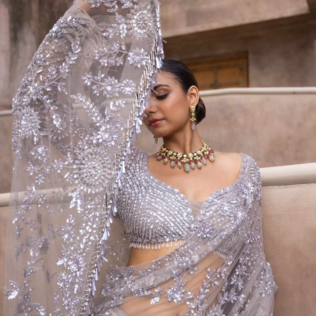 Grey Net saree embellished with Sequin Work and tassels in pallu